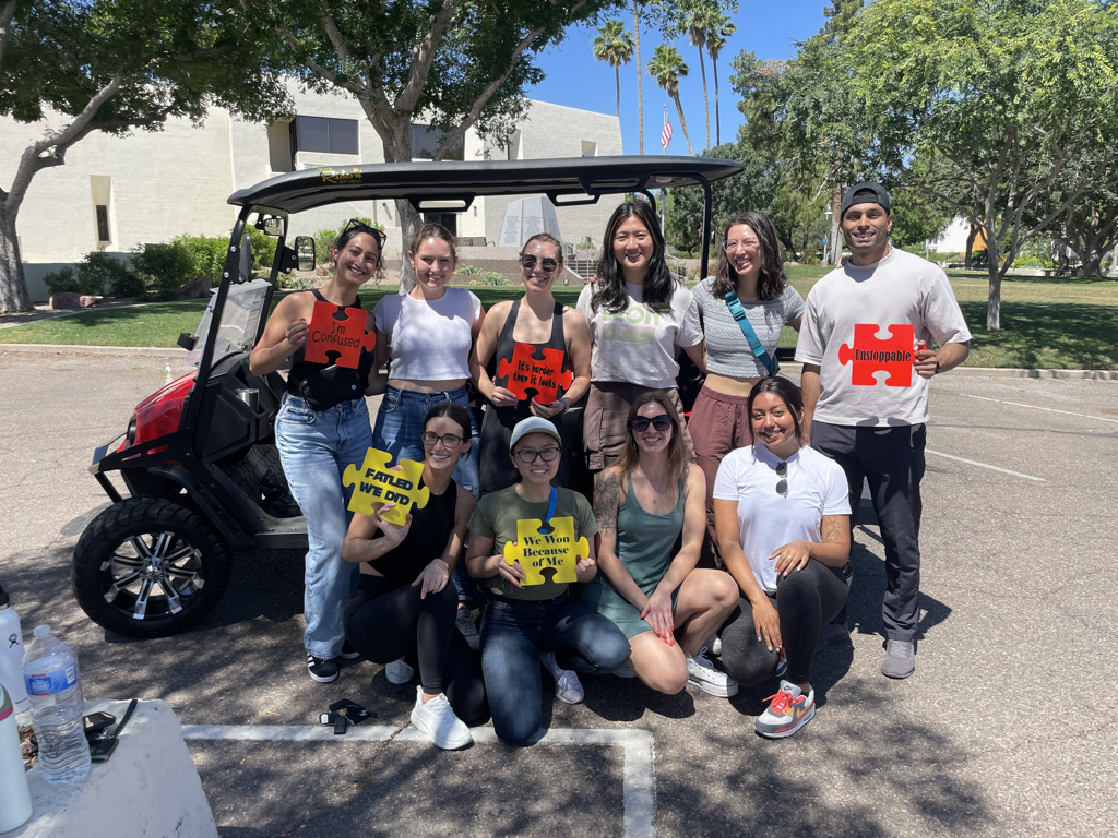 medical studients with a golf cart puzzle ride