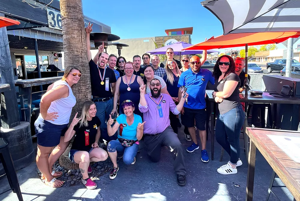 Corporate team collaborating on puzzle challenge during Puzzle Rides team-building event