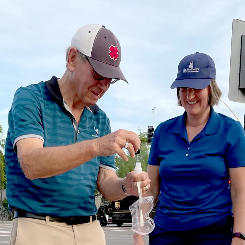 Team in lab coats performing science experiment on Puzzle Rides golf cart in Prescott