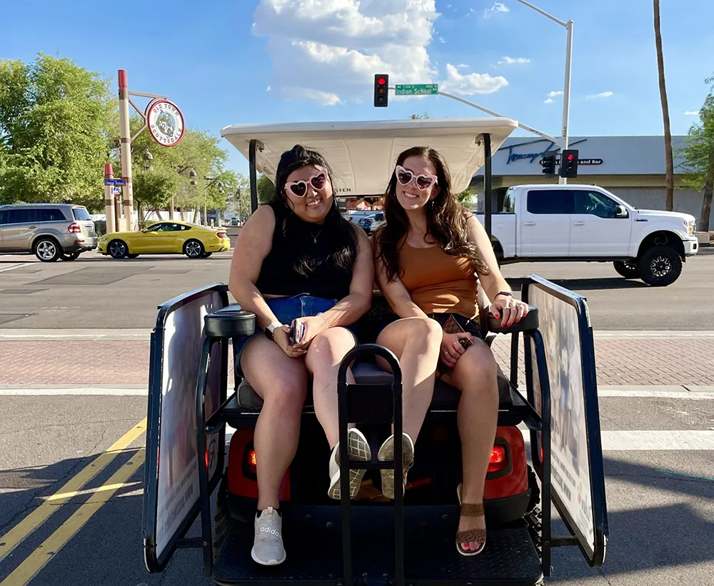 Group enjoying Puzzling Pub Crawl on golf carts in Old Town Scottsdale